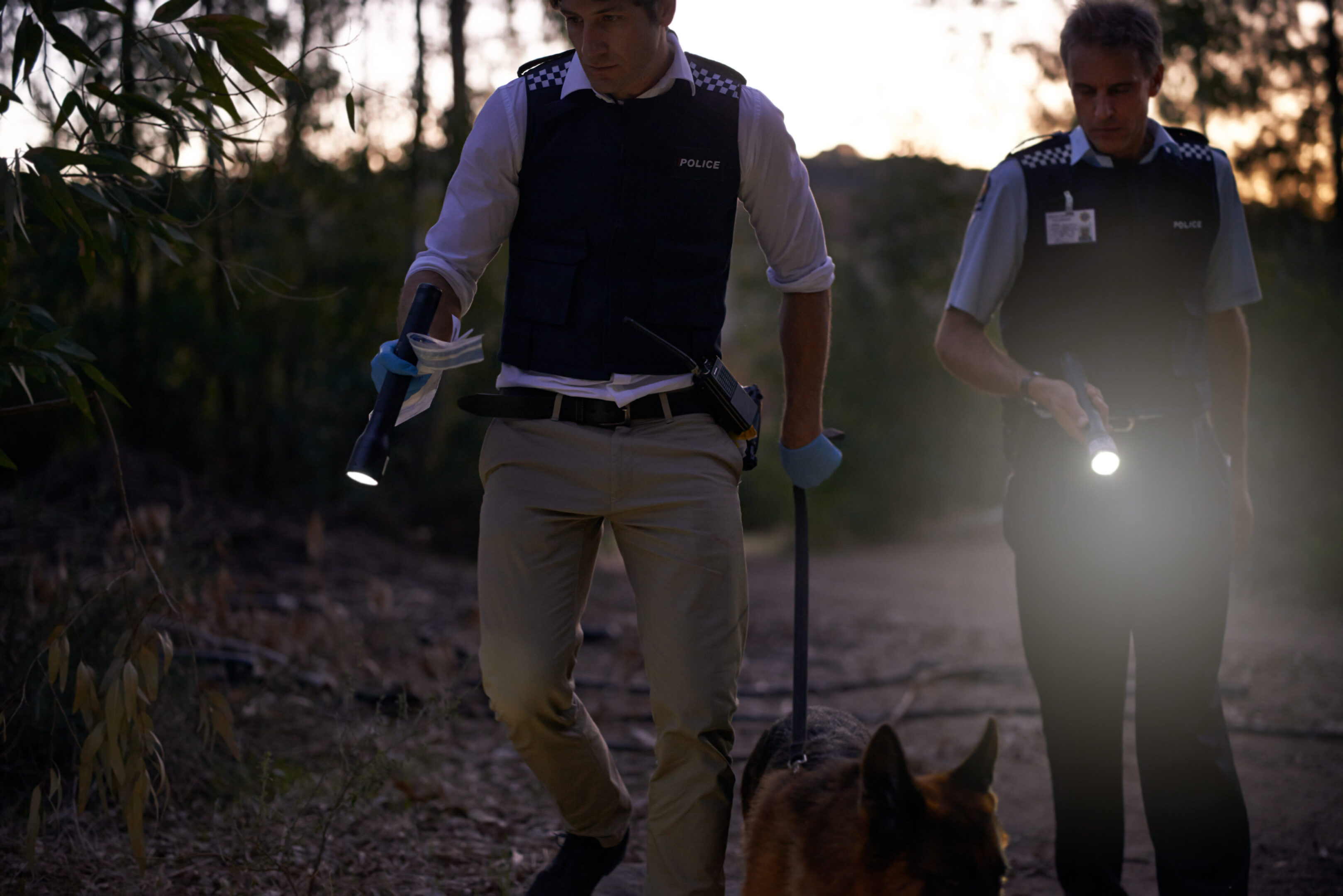 Looking for evidence Shot of two policemen calling for backup